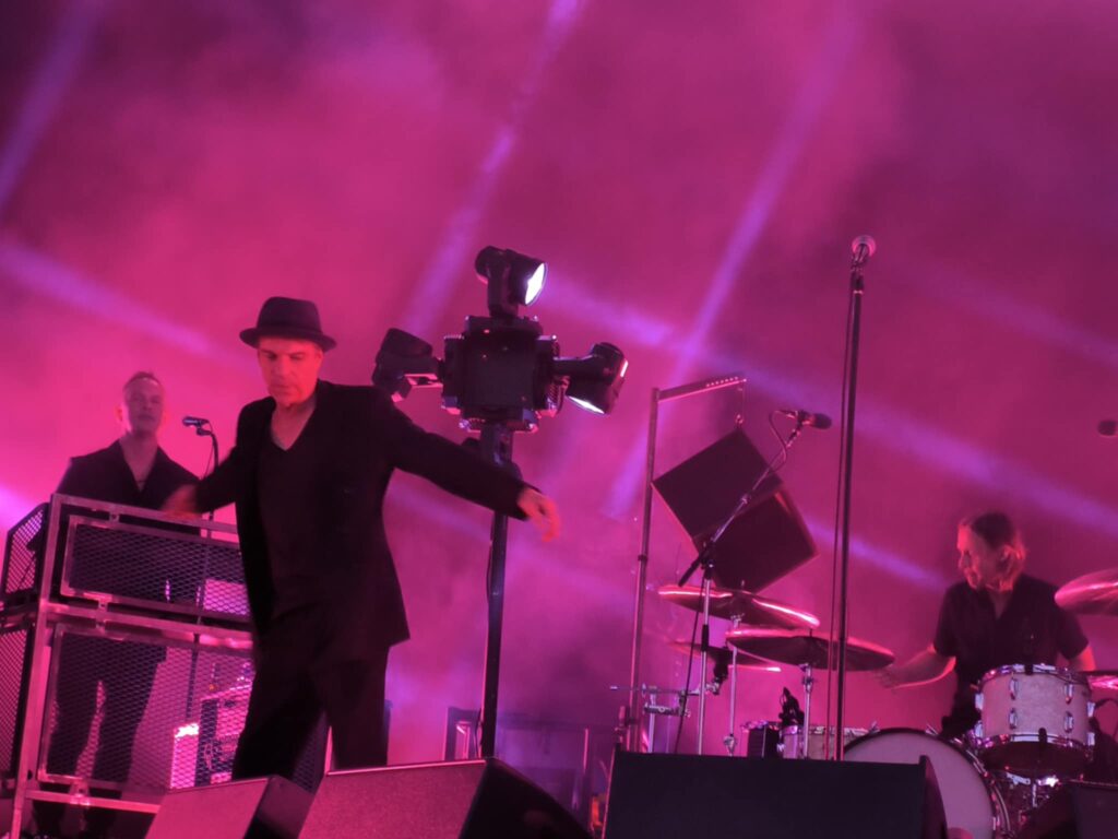 Thåström concert Karlstad – Thåström moving on stage with the band in the background.