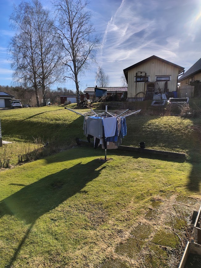 spring in everyday life with clean bed sheets drying on a clothesline in the sun