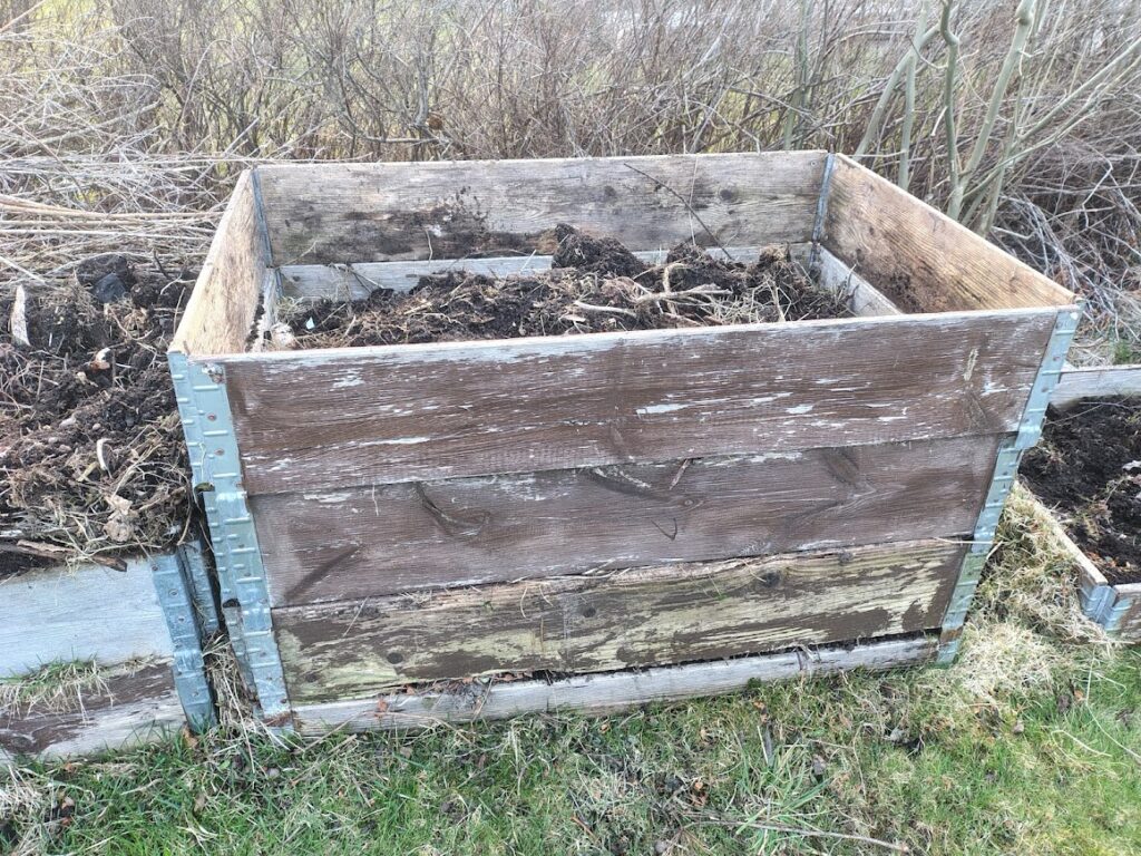 Raised garden beds with soil and compost in garden life in April